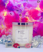Load image into Gallery viewer, A white, two-wick candle with a label that reads 'Diva', positioned in front of a vibrant floral background with decorative items like a high heel shoe and a ring. Southern Charm Farmhouse.