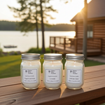 Load image into Gallery viewer, Three mini 4 oz hand poured jars of candles on a wooden surface with a scenic background of a lake and cabin. Southern Charm Farmhouse.
