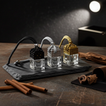 Load image into Gallery viewer, Three small glass perfume bottles with black, silver, and gold accents on a dark stone tray. Southern Charm Farmhouse.