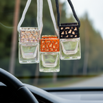 Load image into Gallery viewer, Car air freshener hanging from a rearview mirror with a blurred outdoor background. Southern Charm Farmhouse