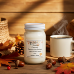 Load image into Gallery viewer, Hand poured Candle labeled 'Caramel Cappuccino Brulee' with a steaming mug of coffee and autumn decor on a wooden surface. Southern Charm Farmhouse.