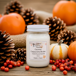 Load image into Gallery viewer, 16 oz mason Jar of hand poured candle labeled Caramel Cappuccino Brulee. surrounded by pumpkins, pinecones, and berries on a wooden surface. Southern Charm Farmhouse.