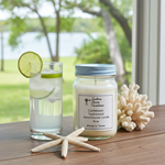 Load image into Gallery viewer, 16 oz Mason Jar hand poured Caribbean Teakwood candle on a wood table with a star fish, coral and Ice water next to it. Southern Charm Farmhouse.