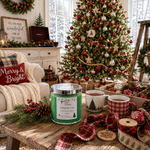 Load image into Gallery viewer, A green scented hand poured candle in a clear glass jar with a silver lid sits on a rustic wooden table in a cozy holiday living room. The scene includes a decorated Christmas tree, mugs of hot cocoa, red plaid ribbon, pinecones, and a white armchair with a 'Merry & Bright' pillow. Candle label reads Christmas Tree. Southern Charm Farmhouse.