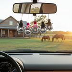 Load image into Gallery viewer, Car interior with disco ball car charms with a cowboy hat and decorative ball on top hanging from the rearview mirror, overlooking a field with horses. Southern Charm Farmhouse.