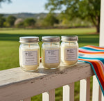 Load image into Gallery viewer, Three 4 oz mini jars of candles on a wooden ledge with a scenic background. Southern Charm Farmhouse.
