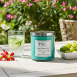 Load image into Gallery viewer, 2 Wick Green Clover & Aloe hand poured candle on a white table outside with Cucumber water and grapes by it. Southern Charm Farmhouse.