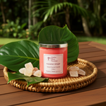 Load image into Gallery viewer, Pink 2 wick hand poured candle labeled 'Hawaiian Ginger' on a woven tray with green leaves and ginger pieces, set against a natural background. Southern Charm Farmhouse