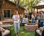Load image into Gallery viewer, Group of people socializing around a fire pit in a backyard setting with a wooden cabin in the background. Woman wearing a Howdy, Howdy, Howdy, Howdy Shirt. Southern Charm Farmhouse.
