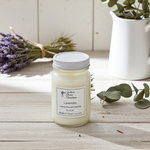 Load image into Gallery viewer, Lavender hand poured candle in a 16 oz Mason jar with a label, surrounded by lavender flowers and eucalyptus leaves on a wooden surface. Southern Charm Farmhouse