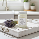 Load image into Gallery viewer, Lavender Candle in a 16 oz. Mason jar on a white wooden tray on a marble countertop with a bundle of lavender beside it. Southern Charm Farmhouse.
