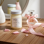 Load image into Gallery viewer, Hand poured Pink Sugar candle with a label, pink ribbon, and perfume bottle on a wooden surface. Southern Charm Farmhouse.