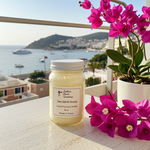 Load image into Gallery viewer, 16 oz Mason Jar hand poured Candle labeled 'Sea Salt & Orchid' with pink flowers on a balcony overlooking a coastal town. Southern Charm Farmhouse.