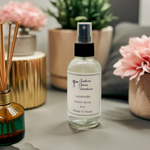 Load image into Gallery viewer, 4 oz. Bottle of Southern Charm Farmhouse lavender room spray on a surface with decorative items in the background. Southern Charm Farmhouse.
