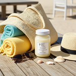 Load image into Gallery viewer, Sun and sand 16 oz mason jar hand poured candle with towels, hat, sunglasses, and shells on a wooden surface. Southern Charm Farmhouse