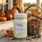 Load image into Gallery viewer, 16 oz mason Jar of 'Toasted Pumpkin Spice' hand poured candle with a basket of autumn-themed items on a wooden surface. Southern Charm Farmhouse.