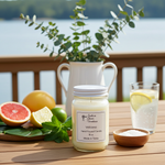 Load image into Gallery viewer, Volcano Candle in a 16 oz. Mason jar wooden table on the deck outside with fruits, a plant, and a glass of lemon water by the lake. Southern Charm Farmhouse.