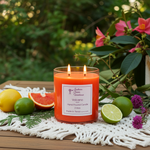 Load image into Gallery viewer, Orange 2 Wick candle labeled 'Volcano' on a wooden surface with fruits and flowers