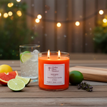 Load image into Gallery viewer, Two Wick hand poured Volcano candle on a wooden surface with fruits and a glass of water, blurred lights in the background. Southern Charm Farmhouse.