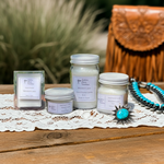 Load image into Gallery viewer, Jars of Western Lace candles and a necklace on a wooden surface with a blurred natural background. Southern Charm Farmhouse.