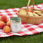 Load image into Gallery viewer, 2 Wick hand poured Candle with a label on a red and white checkered tablecloth, surrounded by peaches and a picnic basket. Cheirosa 62 scent of Pistachio" and "Salted Caramel. Southern Charm Farmhouse.