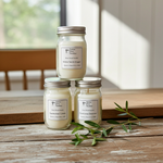 Load image into Gallery viewer, Three hand poured 4 oz candles with labels on a wooden surface near a window. Southern Charm Farmhouse.