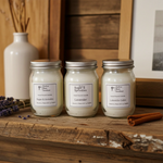 Load image into Gallery viewer, Three mini 4 oz hand poured candles in glass jars with metal lids on a wooden surface, surrounded by decorative items. Southern Charm Farmhouse.