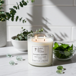 Load image into Gallery viewer, 2 Wick hand poured Eucalyptus Spearmint Candle with a label in a kitchen setting with plants. Southern Charm Farmhouse.