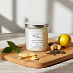 Load image into Gallery viewer, 2 Wick hand poured Candle labeled 'White Tea & Ginger' on a wooden board with ginger, lemon, and tea leaves. Southern Charm Farmhouse.