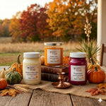 Load image into Gallery viewer, Two 16 oz mason jar hand poured candle and one 2 Wick named Toasted Pumpkin Spice, Fireside Glow and Pumpkin Spice on a wooden surface with pumpkins and autumn leaves, set against a scenic background.  Southern Charm Farmhouse.
