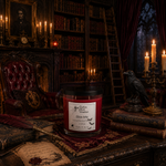 Load image into Gallery viewer, A red wax hand poured candle in a clear glass jar with a black lid sits on a dark wooden desk in a gothic library setting. The label reads 'Bite Me'. Southern Charm Farmhouse.
