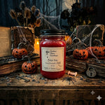 Load image into Gallery viewer, A Halloween-themed hand-poured candle in a 16 oz mason  jar labeled 'Bite Me' sits on a rustic wooden table surrounded by pumpkins, old books, cobwebs, and a black spider decoration. Southern Charm Farmhouse.
