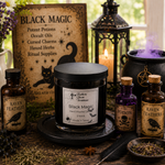 Load image into Gallery viewer, A styled tabletop scene with a black candle jar labeled 'Black Magic' in the center, surrounded by themed props including a sign, lantern, cauldron with purple smoke, and apothecary bottles labeled Raven Feathers, Poison, and Raven Feathers.  Southern Charm Farmhouse.

