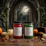 Load image into Gallery viewer, Two jars of hand poured candles labeled 'Dragon's Blood' and ' Poison Apple' in a Halloween-themed setting with pumpkins and cobwebs. Southern Charm Farmhouse.
