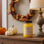 Load image into Gallery viewer, 16 oz mason jar hand poured Candle labeled 'Candy Corn' on a wooden surface with pumpkins and a wreath in the background. Candy Corn Candle | Sweet Halloween Candle | Southern Charm Farmhouse
