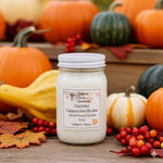 Load image into Gallery viewer, Hand poured Candle jar labeled 'Caramel Cappuccino Brulee' surrounded by pumpkins and gourds on a wooden surface.  Southern Charm Farmhouse.
