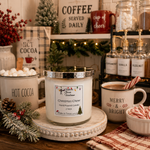 Load image into Gallery viewer, A hand-poured candle in a clear glass jar with a silver lid sits on a white pedestal in a cozy holiday hot cocoa setup. The candle label reads  'Christmas Cheer'. Southern Charm Farmhouse.
