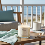 Load image into Gallery viewer, 2 Wick hand poured Coastal Cottage Candle  on a table on a patio with a view of the beach. Southern Charm Farmhouse.
