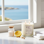Load image into Gallery viewer, 2 wick hand poured Coastal Cottage Candle  with lemon on a windowsill with a coastal view. Southern Charm Farmhouse.
