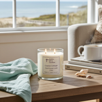 Load image into Gallery viewer, 2 wick hand poured Candle labeled 'Coastal Cottage' on a table with a view of a beach through a window. Southern Charm Farmhouse.
