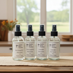 Load image into Gallery viewer, Four bottles of Southern Charm Farmhouse room spray on a burlap surface in the kitchen with a blurred background. 
