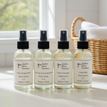 Load image into Gallery viewer, Four bottles of Southern Charm Farmhouse room spray on a windowsill with a laundry basket in the background.
