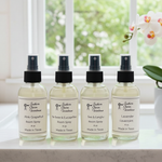 Load image into Gallery viewer, Four bottles of Southern Charm Farmhouse room sprays on a windowsill with a blurred background. 
