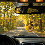 Load image into Gallery viewer, Car interior with a country sunflower car freshie hanging from the rearview mirror, driving on a road surrounded by trees. Southern Charm Farmhouse.
