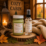 Load image into Gallery viewer, A cozy fall-themed product display featuring a jar candle and a spray bottle from Southern Charm Farmhouse on a rustic wood slice. The scene is decorated with autumn leaves, pinecones, a lit lantern, a knitted blanket, and a wooden sign reading 'COZY CABIN'.
