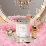 Load image into Gallery viewer, Southern Charm Farmhouse Diva 2-wick luxury candle in a clear container, styled on a vanity with gold accessories and perfume bottles.
