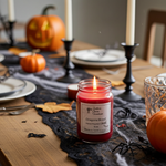 Load image into Gallery viewer, Halloween-themed table setting with a lit hand poured candle labeled 'Dragon's Blood' and decorative pumpkins. Southern Charm Farmhouse.
