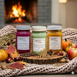 Load image into Gallery viewer, Three 16 oz mason jars hand poured candles labeled, Fireside Glow, Cedar &amp; Autumn Leaves and Fall Festival on a wooden tray with fall decorations in front of a fireplace.  Southern Charm Farmhouse.
