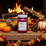 Load image into Gallery viewer, Hand Poured Candle jar labeled 'Fireside Glow' on a wooden surface with pumpkins, leaves, and a fireplace in the background.  Southern Charm Farmhouse.

