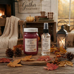 Load image into Gallery viewer, A home fragrance product set from Southern Charm Farmhouse displayed on a rustic wooden table. The set includes a hand-poured candle in a glass jar with a white metal lid and a room spray bottle with a black spray nozzle.
